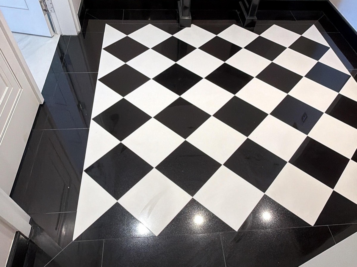 Black and white checkerboard marble floor installation