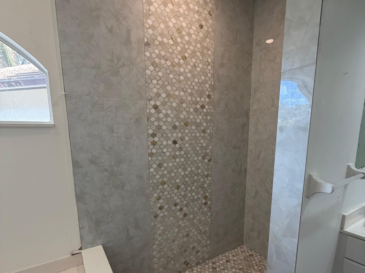 Shower with a marble mosaic accent column in South Florida